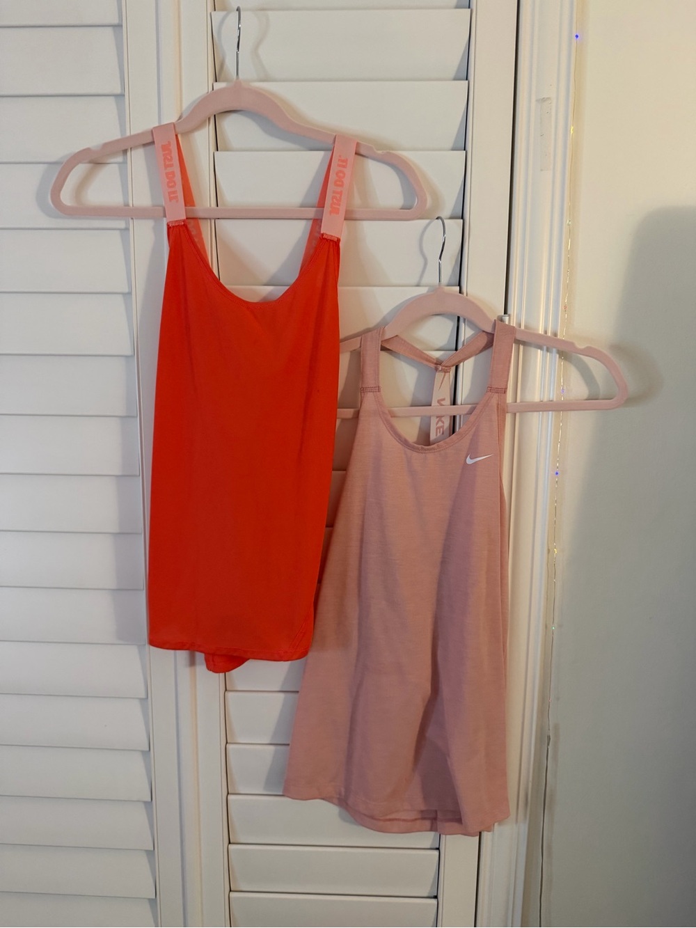 2 Nike Women's Dual Tank Tops in Coral Red and Light Pink